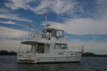 DESIRE at anchor. What a great blue-sky canvas behind this fine yacht! Trawler Training While the Saints Geaux Marching In! Beneteau Swift Trawler 42
