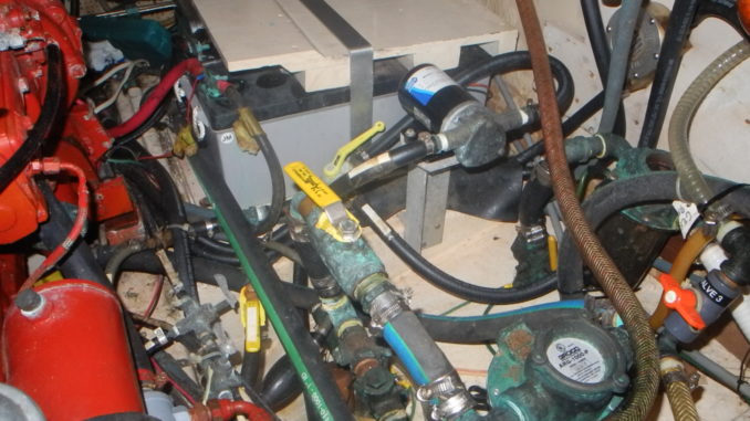 Fuel tank is far right of photo behind RED fuel filter. This engine room is a mess.